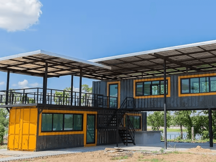 A shipping container home sitting on top of a pile foundation.