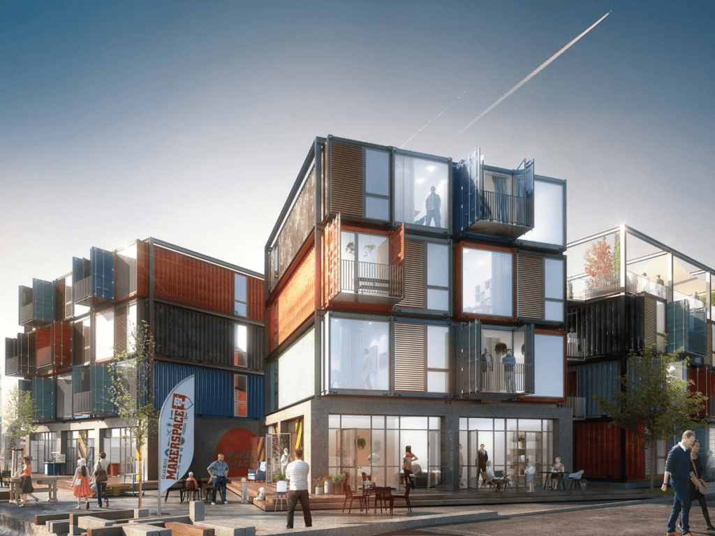 A group of shipping containers stacked on top of one another forming a series of homes & business space.