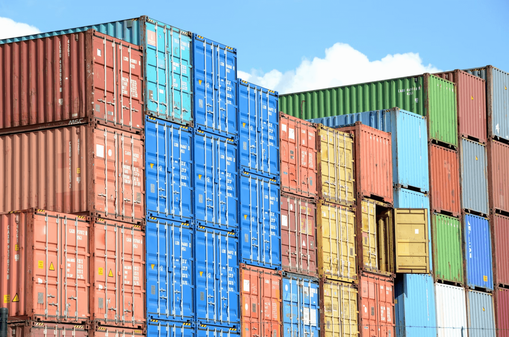 A bunch of colorful shipping containers stacked on top of each other.