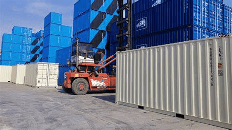 A forklift navigating a number of shipping containers