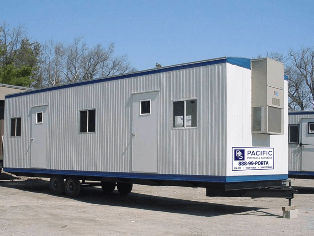 A storage container office trailer setup in a lot.
