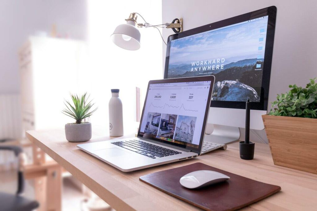 A desk with a laptop and monitor setup on it ready for someone to work