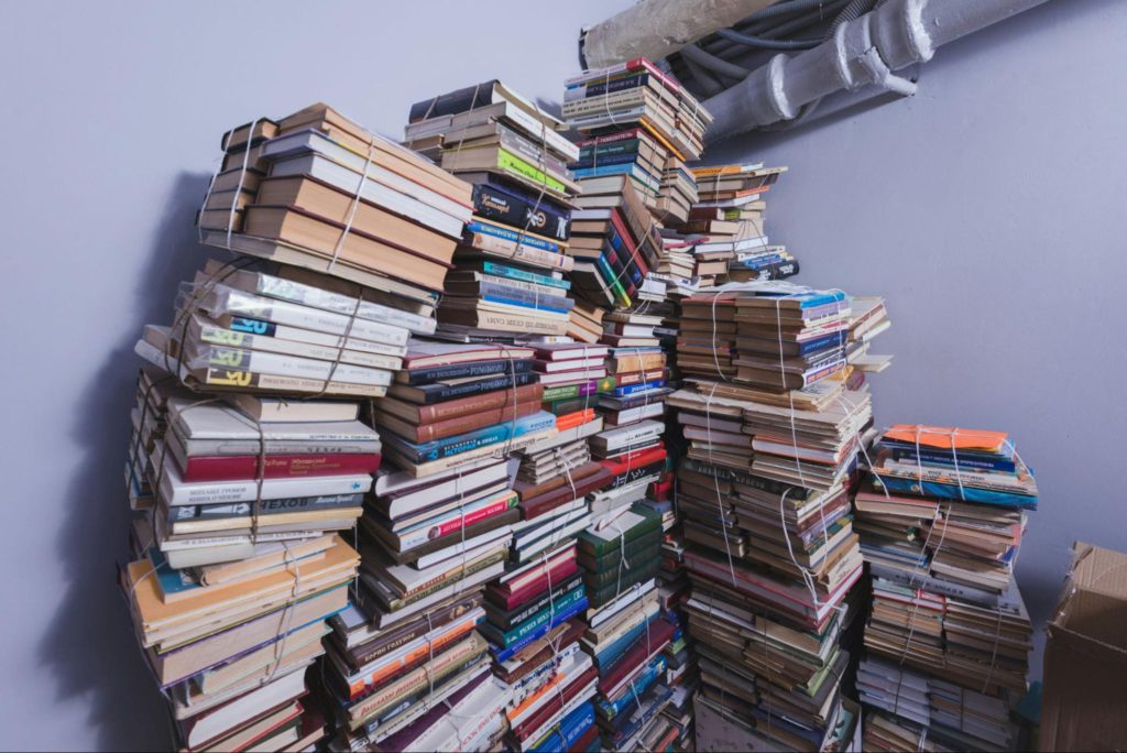 piles of books packed up in storage.