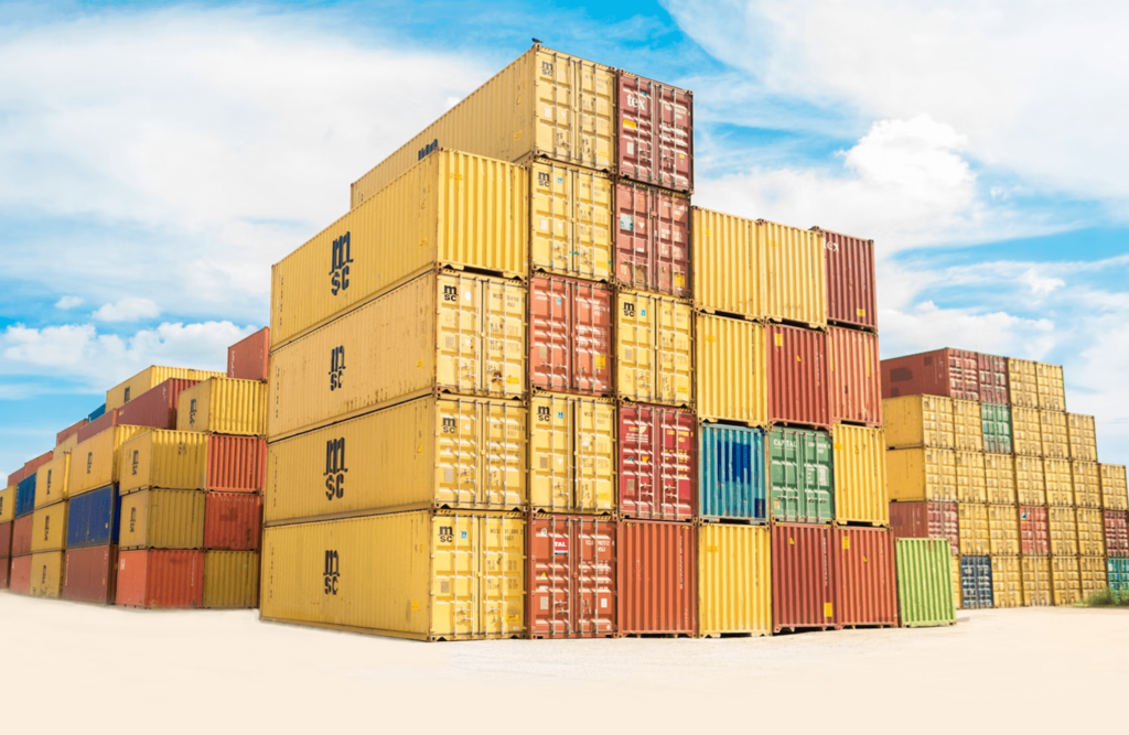 A stack of shipping containers in a shipping yard