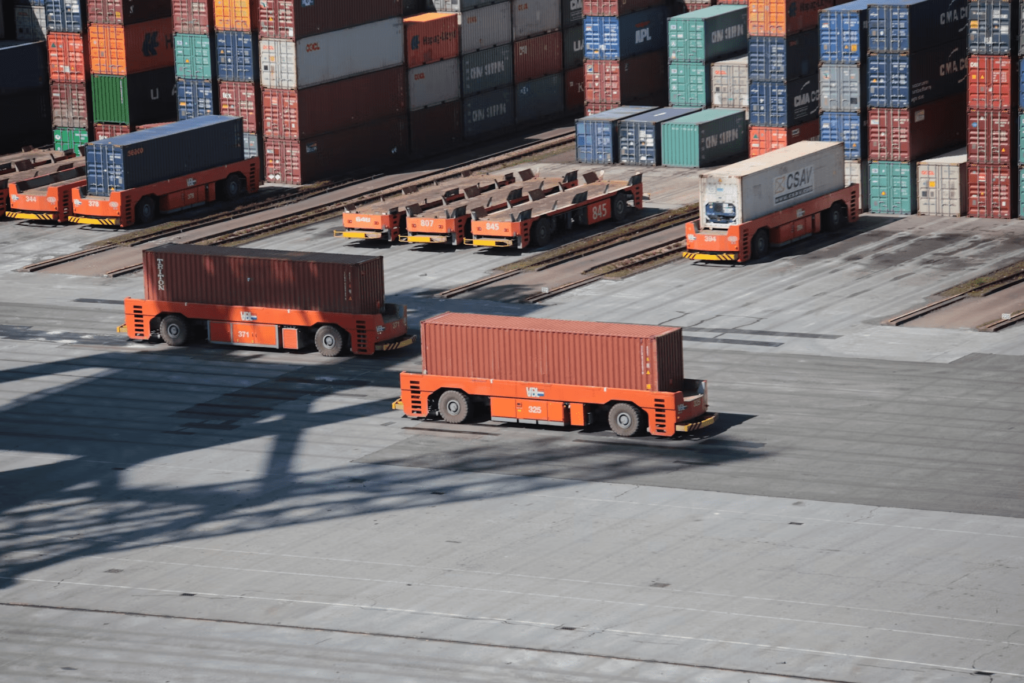 A container being moved in a shipping yard.