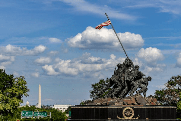 A monument in Arlington, VA with DC in the background