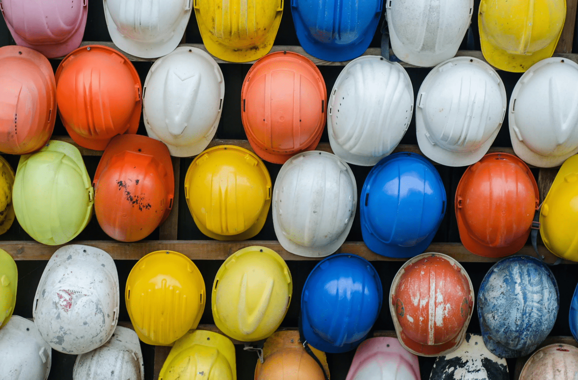 A wall full of hardhats on a construction site