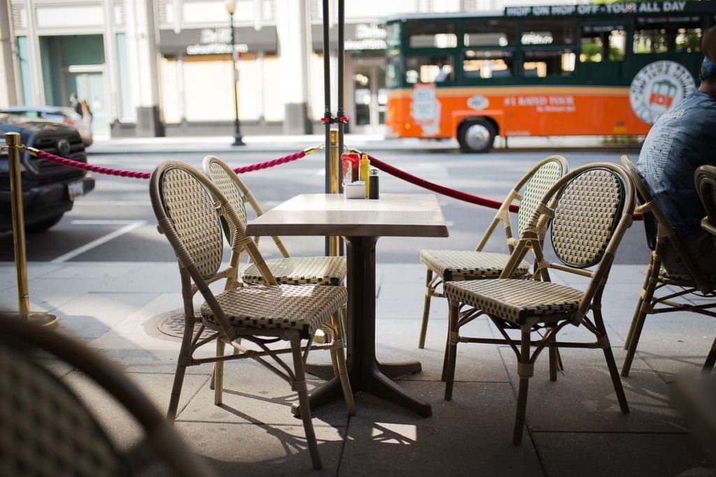 empty chairs sitting outside of a restaurant