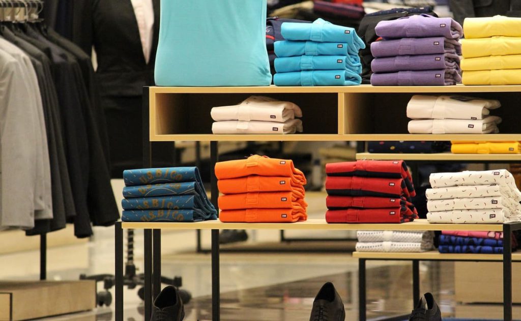 Stacked polo shirts displayed inside a retail store