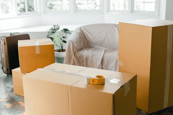 Boxes taped up in a living room preparing to be moved.