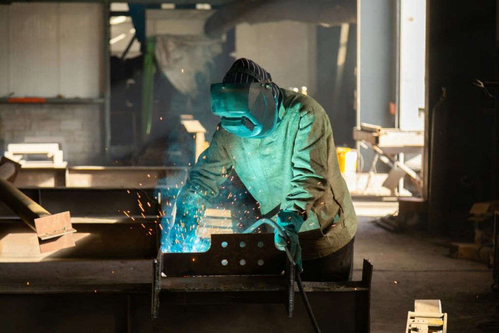 A welder working at a table.