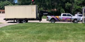 Stuff-It Storage truck hauling a container